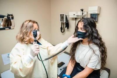 a medical provider examining a girl