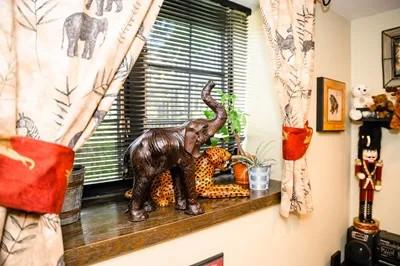 an elephant sculpture on a windowsill