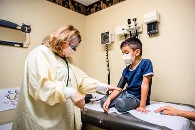 a medical provider examining a boy